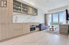 Toronto (Willowdale East) condo for rent - A modern kitchen with wooden cabinets and a large window.