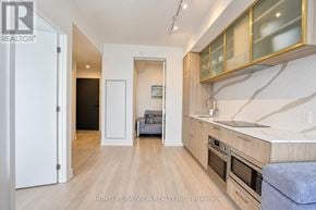 Toronto (Willowdale East) condo for rent - A modern kitchen with wooden floors and a large island.