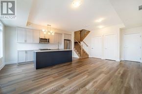 Milton (Cb Cobban) townhouse for rent - A spacious kitchen with a staircase in the background.