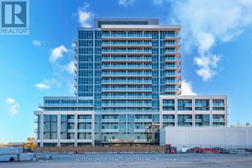 Milton (Tm Timberlea) condo for rent - A large building with a glass facade is under construction with a truck parked in front.