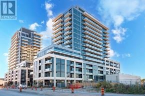 Milton (Tm Timberlea) condo for rent - A large, modern building with many windows is under construction.