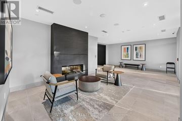 Milton (Tm Timberlea) condo for rent - A modern living room with a fireplace and a large painting on the wall.
