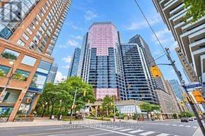 Toronto (Bay Street Corridor) condo for rent - A city street with a pink building in the background.