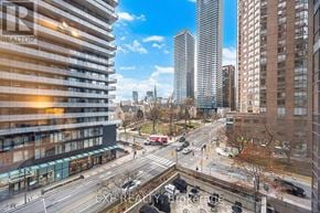 Toronto (Bay Street Corridor) condo for rent - A city street with cars and buildings.