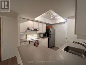 Toronto (Bay Street Corridor) condo for rent - A kitchen with a refrigerator, stove, and sink.