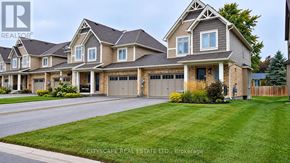Grey Highlands townhouse for rent - A large, well-maintained house with a driveway in front.