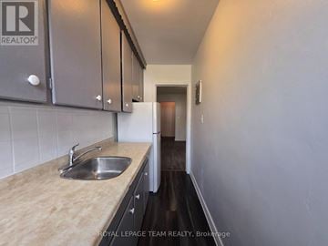 Ottawa multi-family for rent - A kitchen with a sink and cabinets.
