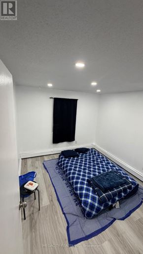 Guelph (Grange Road) apartment for rent - A room with a bed, chair, and a window.