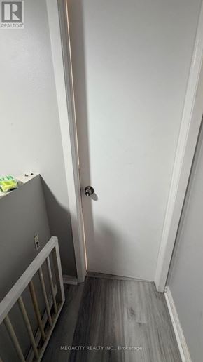 Guelph (Grange Road) apartment for rent - A white door with a handle is in the middle of a hallway.