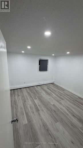 Guelph (Grange Road) apartment for rent - A room with a wooden floor and a door.