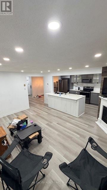 Guelph (Grange Road) apartment for rent - A living room with a kitchen in the background and a dining table with chairs in the foreground.