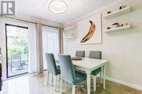 Mississauga (Sheridan) townhouse for rent - A dining room with a white table and grey chairs.