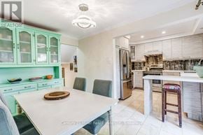 Mississauga (Sheridan) townhouse for rent - A kitchen with green cabinets and a white table.