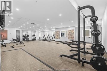 Lasalle condo for rent - A gym with a variety of equipment including weights and benches.