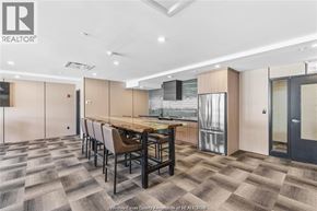 Lasalle condo for rent - A modern kitchen with a dining table and chairs.