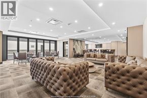 Lasalle condo for rent - A living room with a brown tufted sofa and a grey carpet.