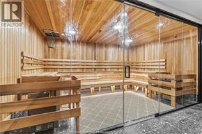 Lasalle condo for rent - A room with wooden walls and ceiling, furnished with wooden benches and tables, and a glass door leading to a balcony.
