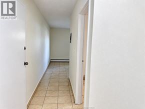 Windsor apartment for rent - A hallway with tiled flooring and white walls.