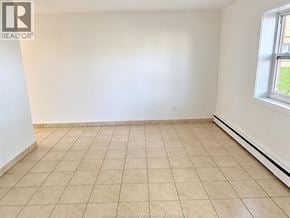 Windsor apartment for rent - A room with tiled flooring and a window on the right side.