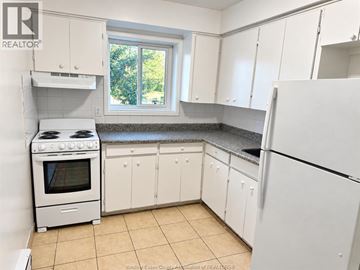 Windsor apartment for rent - A kitchen with white appliances and cabinets.