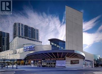 Toronto (Willowdale West) apartment for rent - A modern building with a glass facade and a sign that reads "Encore Entertainment.".