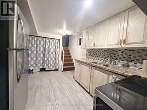 Toronto (Wexford-Maryvale) apartment for rent - A kitchen with a refrigerator, sink, and cabinets.