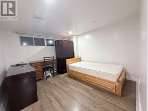 Toronto (Wexford-Maryvale) apartment for rent - A bedroom with a bed, dresser, and chair.