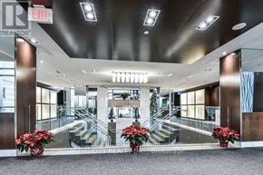 Toronto (Islington-City Centre West) condo for rent - A lobby with a staircase and a Christmas tree.
