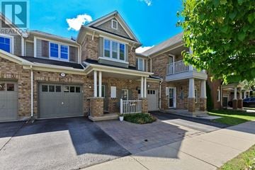 Milton (Co Coates) townhouse for rent - A large house with a grey garage door is for sale.