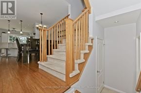 Milton (Co Coates) townhouse for rent - A wooden staircase with a white carpeted landing.