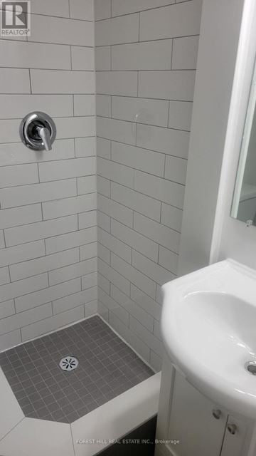 Toronto (Dovercourt-Wallace Emerson-Junction) condo for rent - A white sink in a white tiled bathroom.