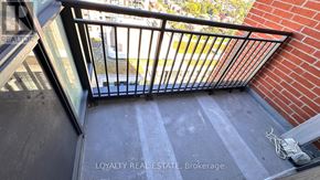 Toronto (Yorkdale-Glen Park) condo for rent - A metal railing on a balcony with a brick wall and a glass door.