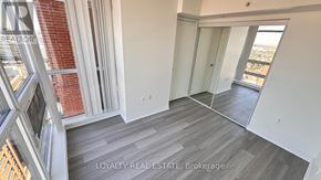 Toronto (Yorkdale-Glen Park) condo for rent - A room with a wooden floor and a large window.
