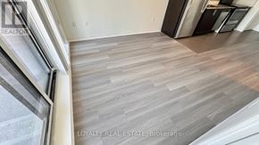 Toronto (Yorkdale-Glen Park) condo for rent - A room with wooden flooring and a window.