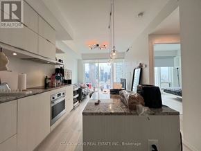 Toronto (Church-Yonge Corridor) condo for rent - A kitchen with a granite countertop and white cabinets.