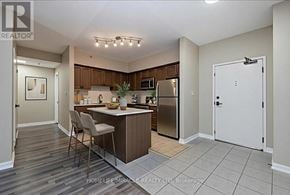 New Tecumseth (Alliston) condo for rent - A kitchen with a refrigerator, sink, and countertop.