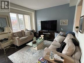 Vaughan (Patterson) townhouse for rent - A living room with a couch, chair, and television.