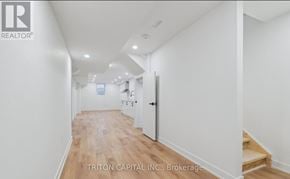 Barrie apartment for rent - A hallway with a wooden floor and white walls.