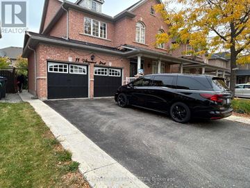 Brampton (Bram East) apartment for rent - A black SUV is parked in front of a brick house with a garage.