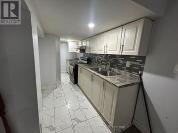 Brampton (Bram East) apartment for rent - A kitchen with white cabinets and a black and white tiled floor.