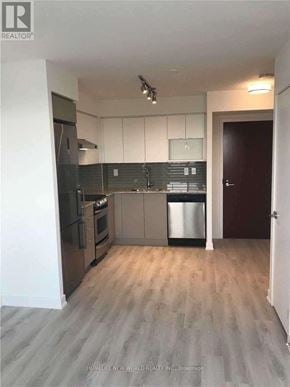 Toronto (Yorkdale-Glen Park) condo for rent - A kitchen with a refrigerator, oven, and microwave.