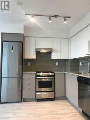 Toronto (Yorkdale-Glen Park) condo for rent - A modern kitchen with a stainless steel refrigerator and oven.