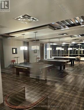 Mississauga (City Centre) condo for rent - A modern office space with a glass table and chairs.