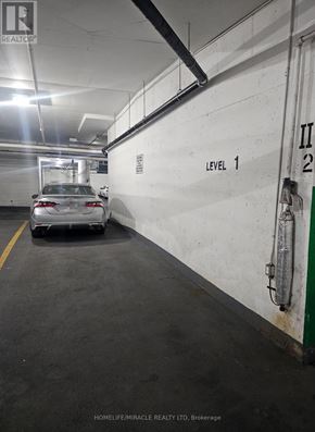 Mississauga (City Centre) condo for rent - A car is parked in a parking garage on level 1.