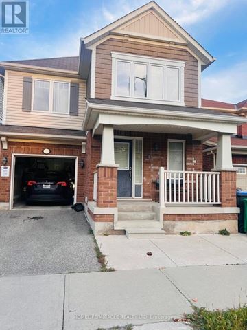 Brampton (Northwest Brampton) apartment for rent - A two-story house with a garage and a car parked in it.