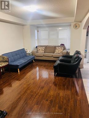 Brampton (Northwest Brampton) apartment for rent - A living room with a blue couch and a brown couch.