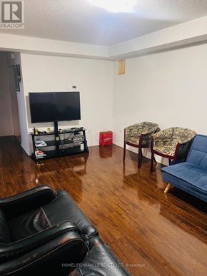 Brampton (Northwest Brampton) apartment for rent - A living room with a black leather chair and a blue sofa.