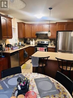 Brampton (Northwest Brampton) apartment for rent - A kitchen with a table and chairs in the foreground.