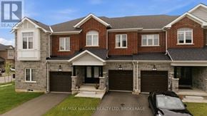 Thorold (Rolling Meadows) townhouse for rent - A large, two-story house with a brick facade and a black car parked in front.