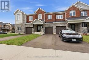 Thorold (Rolling Meadows) townhouse for rent - A black car is parked in front of a brick house.